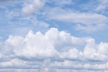 Texture background of blue sky with fluffy cumulus clouds. White clouds on a blue background....