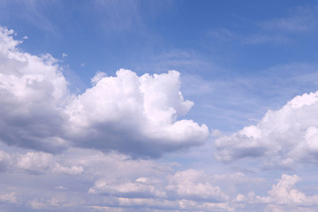 Naklejka na ściany i meble Texture background of blue sky with fluffy cumulus clouds. White clouds on a blue background. Horizontal. Concept of nature and meteorology.
