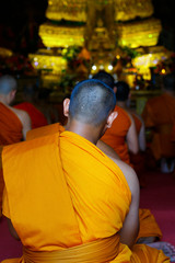 head of monk praying in buddhist temple