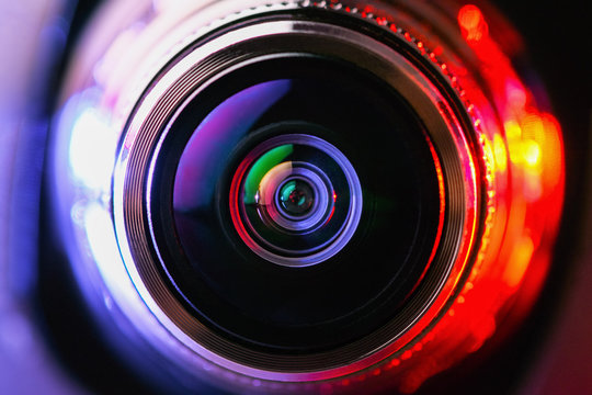 Close-up camera lens with purple and red backlight. Optics. Gorizontal photo
