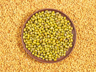 Green gram in clay plate. Background from Fenugreek. Indian cuisine ingredients
