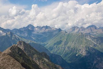 Fototapeta premium Mountains scene with dramatic cloudy sky in national park of Dombay