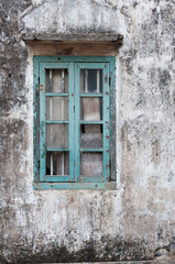 Fototapeta na wymiar Broken window of an abandoned residential building
