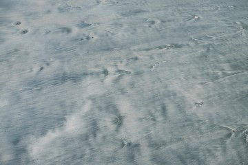 Black sand after the wave is falling
