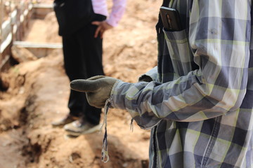 Construction workers are on the construction site and have phones in their pockets