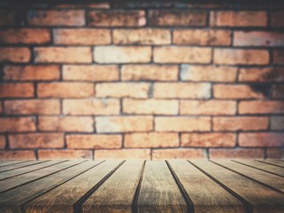 On top of an empty wooden table, the backdrop is a wall of blocks