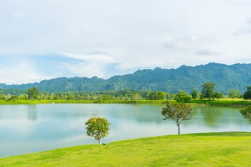 beautiful landscape overlooking the lake with clear clear water which reflects the mountains covered with green grass