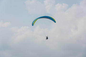 Blue paraglider flying in the sky