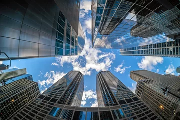 Foto auf Glas Uprisen angle with fisheye scene of Downtown Chicago skyscraper with reflection of clouds among high buildings which have airplane flying over the sky, Illinois, United States, Business concept © THANANIT
