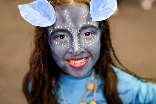 A girl, with her face painted like a character from the movie "Avatar", poses for photographs during the Leisure and Fantasy Lounge "SOFA" in Bogota