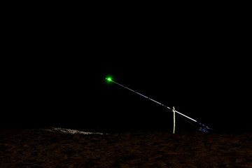 sanctifying fishing rods at night, the front and back background is blurred with bokeh effect