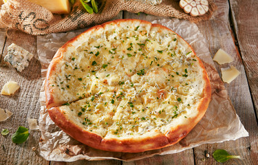 Pizza Restaurant Menu - Delicious Fresh Pizza 4 cheese. Pizza on Rustic Wooden Table with Ingredients