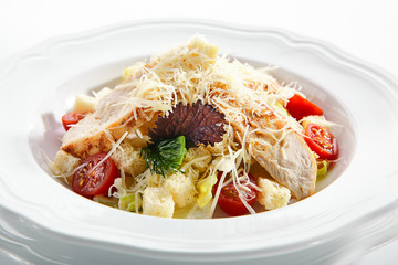 Caesar salad with roasted chicken breast, croutons, cherry tomatoes and grated parmesan cheese