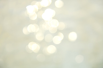 Soft focus bokeh light effects over a rippled