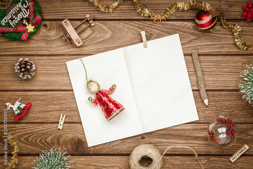 Aufkleber top view of blank notebook on wood background with xmas decorations. mockup christmas background wit