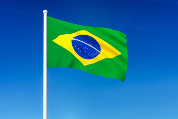 Waving flag of Brazil on the blue sky background