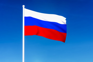 Waving flag of Russia on the blue sky background