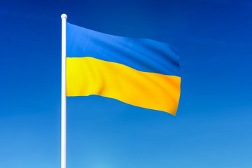 Waving flag of Ukraine on the blue sky background