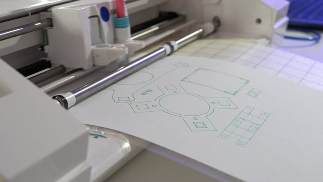 A drawing plotter draws a schematic of industrial details. Device design