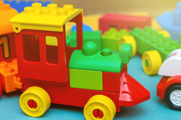 pack of colorful child kid’s education toys constructor train pattern background on the bright color background close up. Childhood education play infancy children baby concept