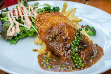 Fried pork chop with french fries  and vegetables