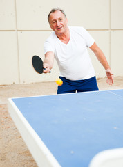 mature man starts a party at ping pong at outdoor