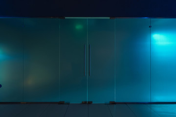 Doors and frosted glass wall. Blue tint