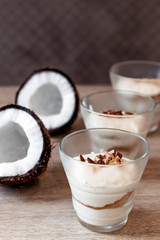 Coconut tender dessert in cafe. Dessert in glass for Valentine's day. Vertical photo.