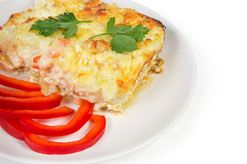 Cauliflower and seafood gratin portion, red bell pepper slices