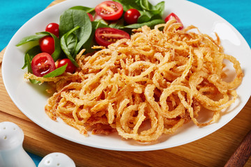 close-up of fresh salad and fried onions
