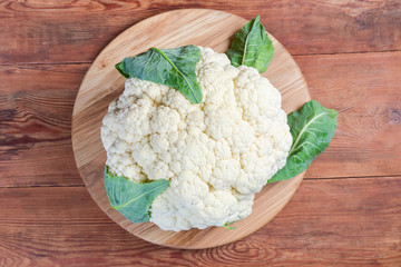 Top view of the cauliflower head on the wooden surface
