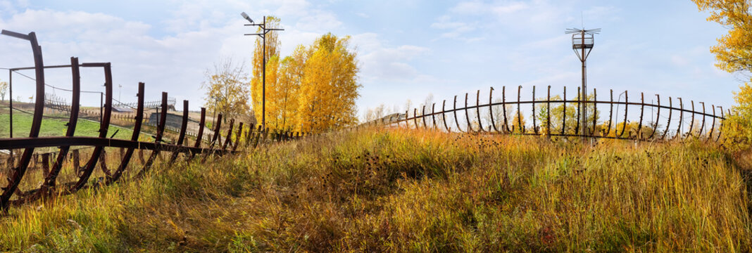Remains of steel framework abandoned wooden luge track in autumn