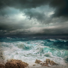 Stormy sea view  near coastline at evening time. Waves, splashed