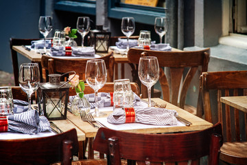 Tables in a street cafe waiting for the guests