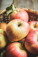 Freshly harvested ripe apple on the rustic wooden background. Selective focus. Shallow depth of field.