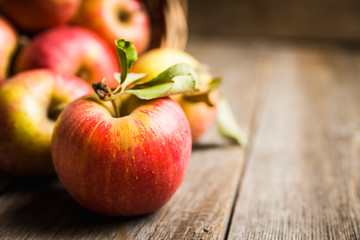 Freshly harvested ripe apple on the rustic wooden background. Selective focus. Shallow depth of...