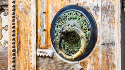 Door metal handle, round handle, old wooden door