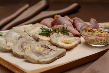 Sliced meat on a board with greens. For the menu