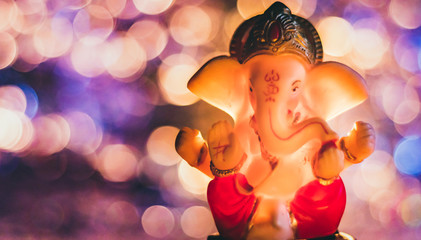 Matte effect on a low light shot of ganesh statue with beautiful, colored boken in the background. God of Good-omen and wisdom