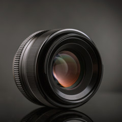 Black lens on a dark background, close-up. Photographer Toolkit