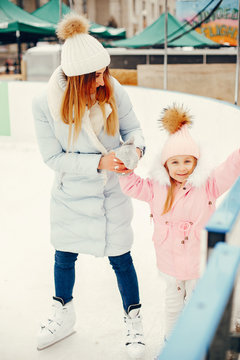 Family In A Winter Park. Mother With Daughter In A Ice Arena