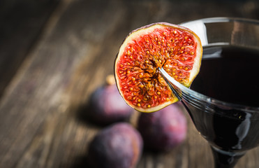Martini cocktail with black vodka and figs on the rustic background. Selective focus. Shallow depth of field.