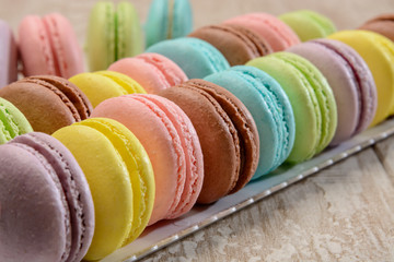 French colorful macarons on the wooden table.