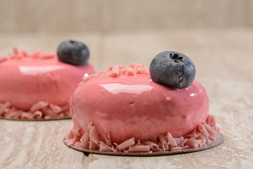 Bright cakes with blueberries poured with pink syrup.