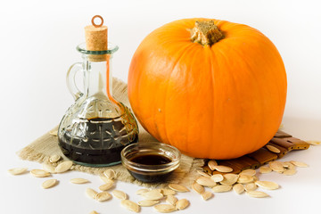 pumpkin, pumpkin seed oil in a bottle and pumpkin seeds, isolate
