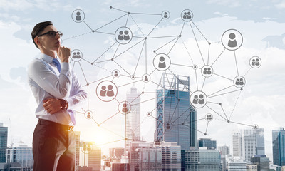 Concept of business success and control with confident boss against cityscape background