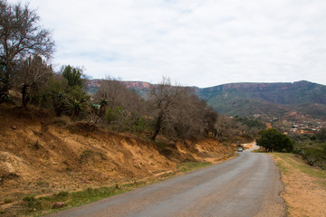 Fototapeta premium Rural Road Heading Downhill into Valley in Kwazulu-Natal