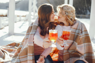 young blonde mom with her grown up daughter in the spring park