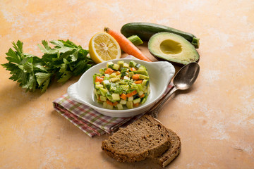 tartar salad with avocado carrots zucchinis and celery