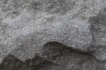 Close-up of rugged stone wall, background with grunge texture
